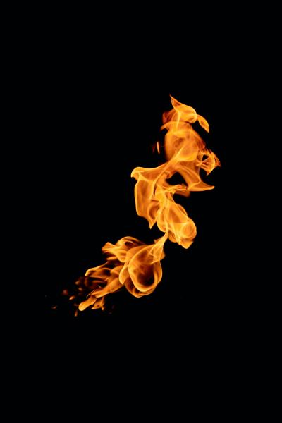 A photograph of a small flame against a black background. 