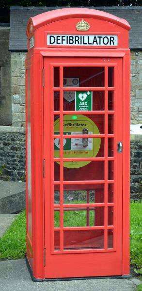 A photograph of a community defibrillator in an old phone box. 