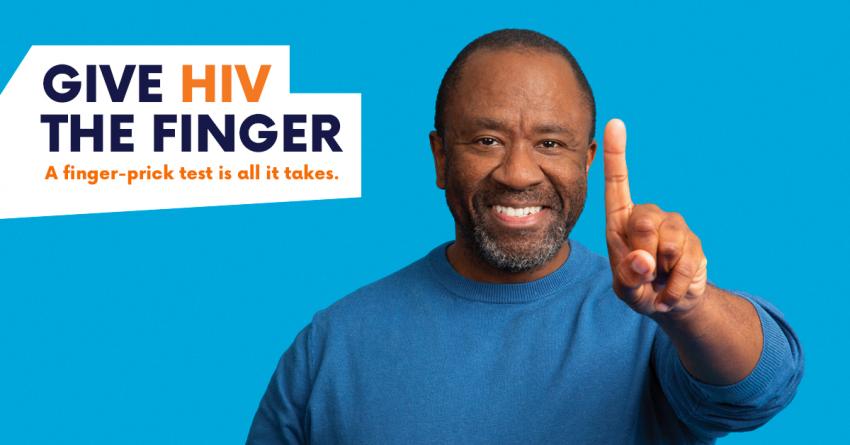 Black man holds up finger - text reads Give HIV the Finger