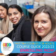 A photo of three adult learners sat at a desk with the caption &#039;part-time courses for adults, course guide 2022/23, enrolling now&#039;.