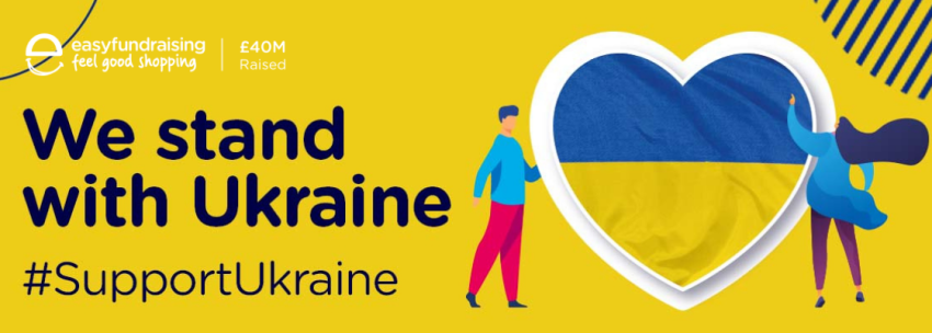 A cartoon drawing of two people looking at the Ukrainian flag in the shape of a heart. Written next to it is &#039;We stand with Ukraine&#039; and the easyfundraising logo.